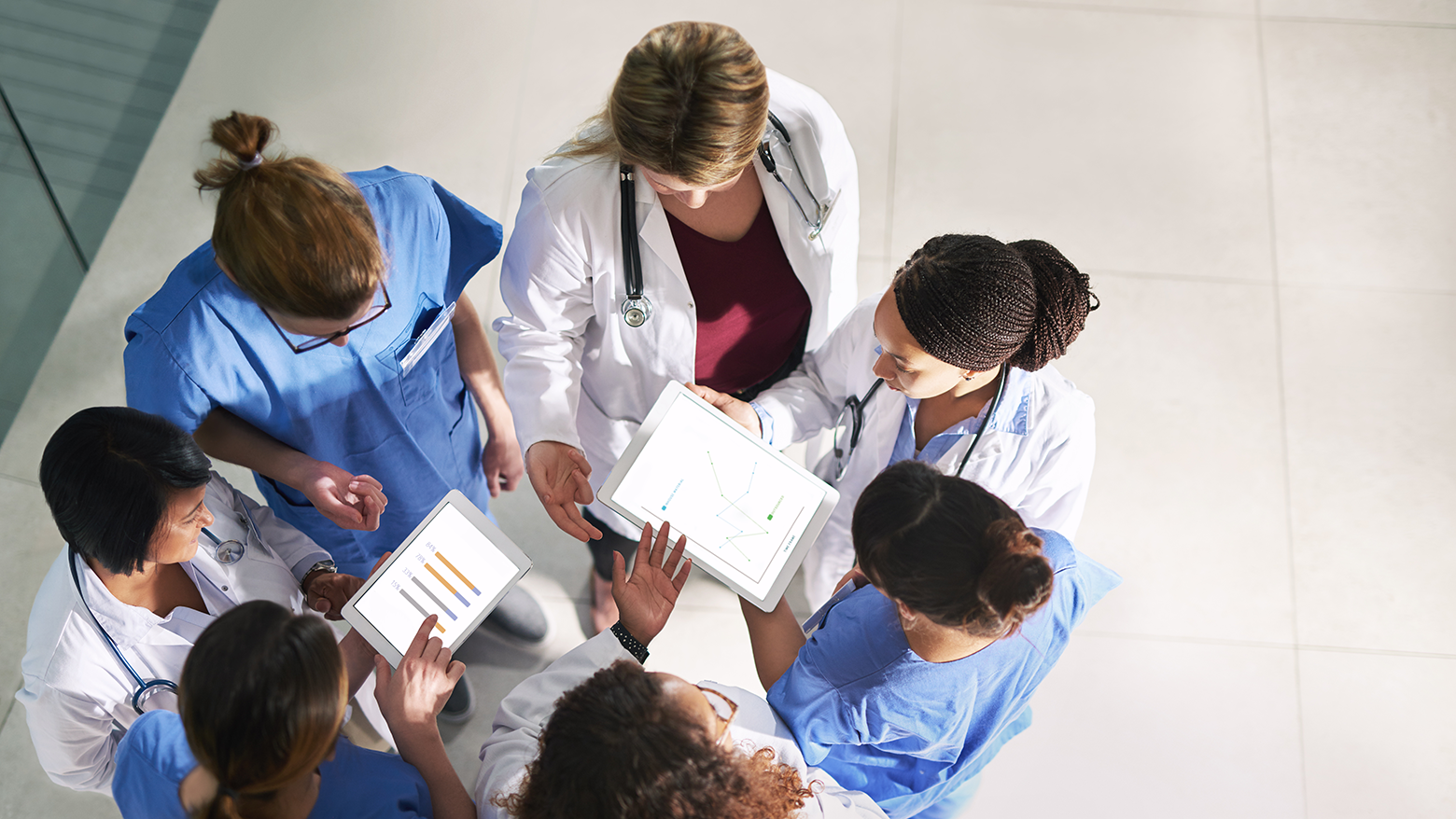 A group of doctors huddle to discuss paperwork