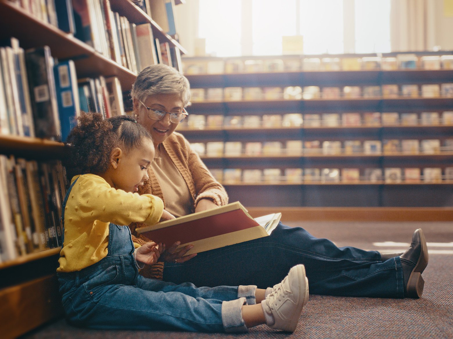 A father reads a picture book with his young daughter